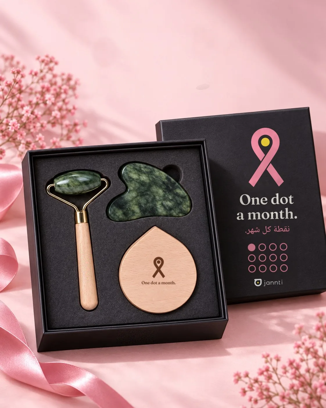 The Dot Box: a jade roller, gua sha and engraved beech piece in a black box printed with the ribbon
