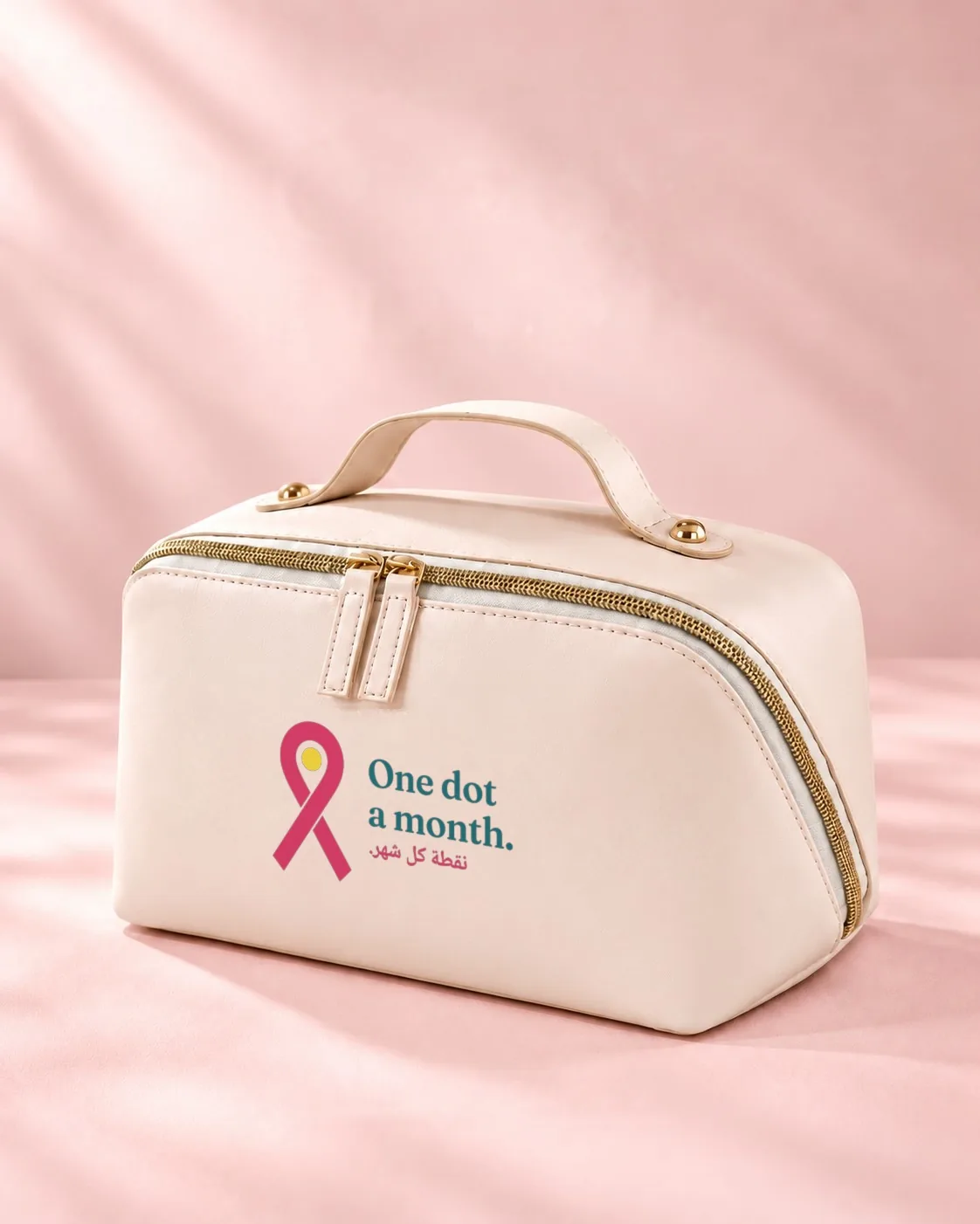 Essentials: a cream cosmetic bag printed with the pink ribbon and One dot a month